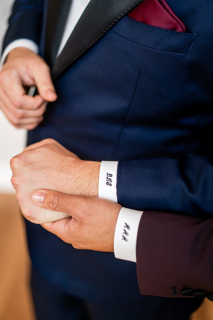 Monogrammed shirt cuffs with a navy tuxedo