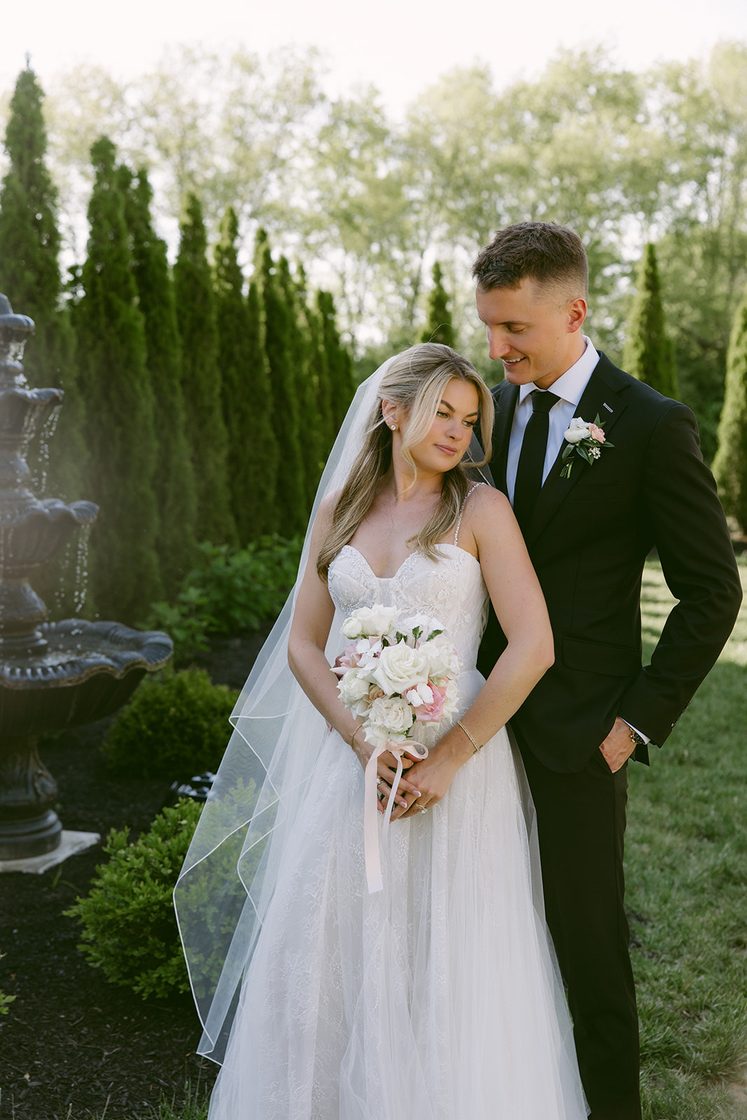 Bride and groom at the garden fountain